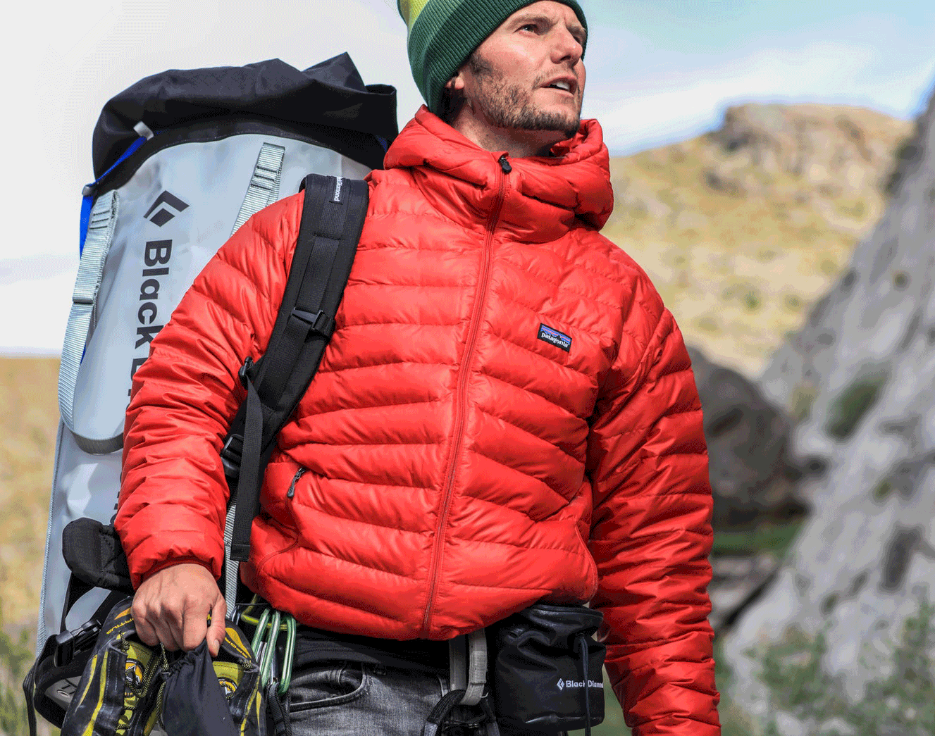 Mountain climber in Patagonia jacket preparing to climb with equipment